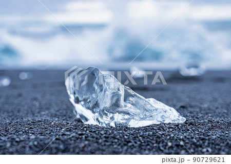 Close-up of beautiful ice chunk on black sand shore of Diamond beach Close-up of beautiful ice chunk on black sand shore of Diamond beach 90729621