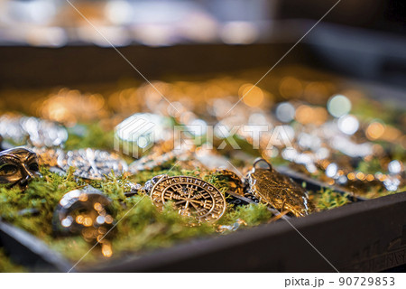 Collection of various Viking jewelry in moss tray on display at gift shop Collection of various Viking jewelry in moss tray on display at gift shop 90729853