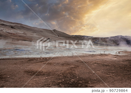 View of steam emitting from crater in geothermal area of Hverir during sunset View of steam emitting from crater in geothermal area of Hverir during sunset 90729864
