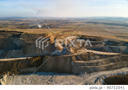 Aerial view of open pit mine of sandstone materials for construction industry with excavators and dump trucks. Heavy equipment in mining and production of useful minerals concept 90732041
