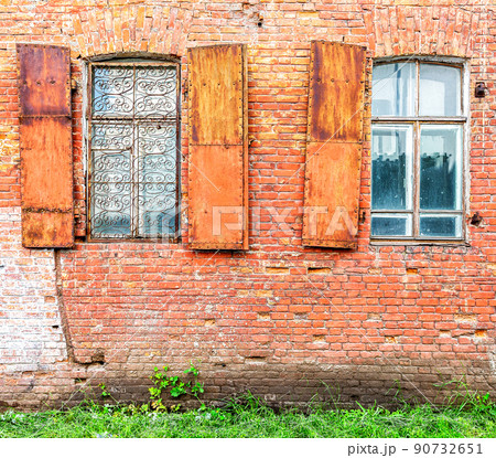 Old building brick wall with an window with hinged shutters Old building brick wall with an window with hinged shutters 90732651