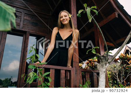 Cheerful female chilling on veranda Cheerful female chilling on veranda 90732924
