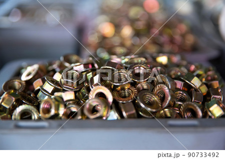 Closeup of metall nuts abstract industrial background 90733492
