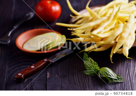 Green and yellow bean pods of asparagus on old rustic wooden table. Green and yellow bean pods of asparagus on old rustic wooden table. 90734818