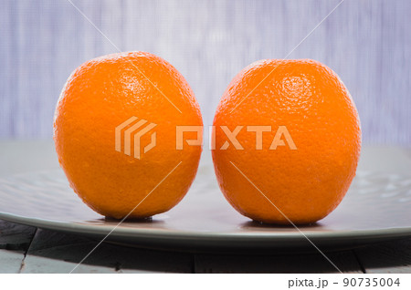 delicious spanish orange on a wooden table, one cut in half.Fresh juicy oranges on the table. 90735004