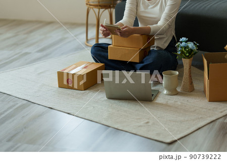 A portrait of Asian woman, e-commerce employee freelance with parcel box for deliver to customer. Online marketing packing box delivery concept. A portrait of Asian woman, e-commerce employee freelance with parcel box for deliver to customer. Online marketing packing box delivery concept. 90739222