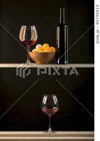 Still life with multicolored balls in a plate, a bottle and glasses of wine Still life with multicolored balls in a plate, a bottle and glasses of wine 90740914