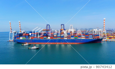 Arial view by drone camera transportation logistics and container dock cargo yard with working crane bridge in shipyard with transport logistic import export with blue sky background. 90743412