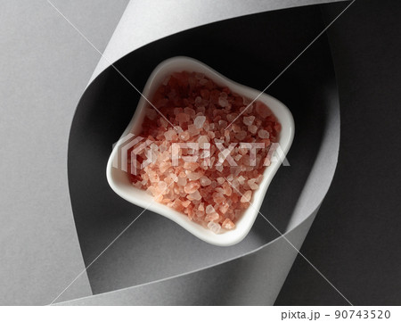Pink salt in a white ceramic bowl. 90743520