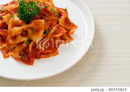 farfalle pasta in tomato sauce with parsley farfalle pasta in tomato sauce with parsley 90743823
