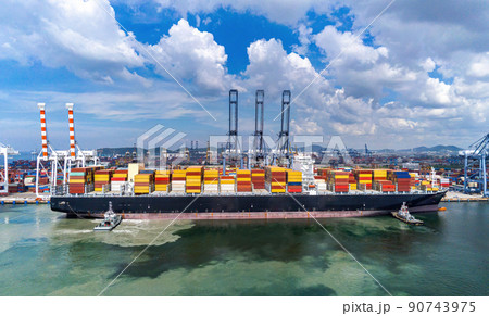 Arial view by drone camera transportation logistics and container dock cargo yard with working crane bridge in shipyard with transport logistic import export with blue sky background Arial view by drone camera transportation logistics and container dock cargo yard with working crane bridge in shipyard with transport logistic import export with blue sky background 90743975