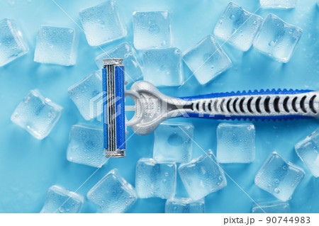 Refreshing shaving machines for the face against the background of frosty ice cubes 90744983