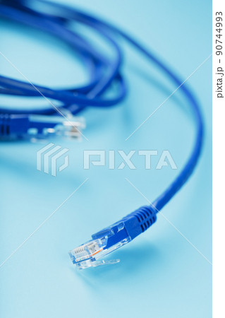 Blue Ethernet Cable Cord Patch cord on a blue background with free space Blue Ethernet Cable Cord Patch cord on a blue background with free space 90744993