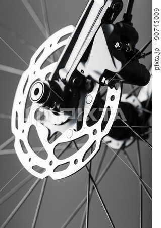 Shiny bicycle brake rotor close-up in macro with selective focus Shiny bicycle brake rotor close-up in macro with selective focus 90745009