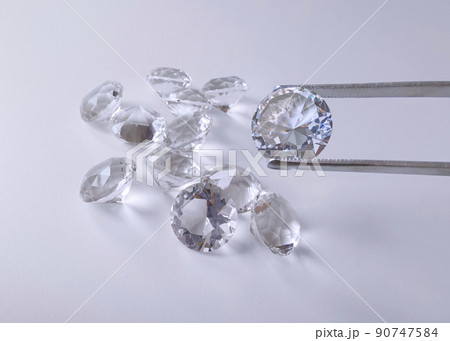 brilliant cut diamond held by tweezers brilliant cut diamond held by tweezers 90747584