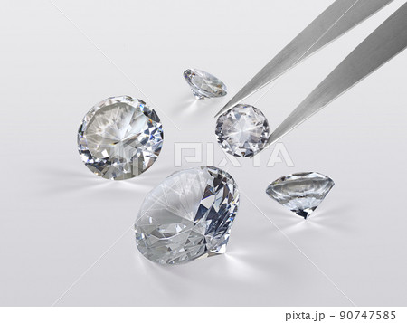 brilliant cut diamond held by tweezers brilliant cut diamond held by tweezers 90747585