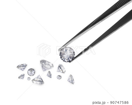 brilliant cut diamond held by tweezers brilliant cut diamond held by tweezers 90747586