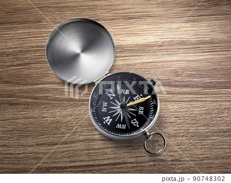 compass on the brown wooden table background 90748302