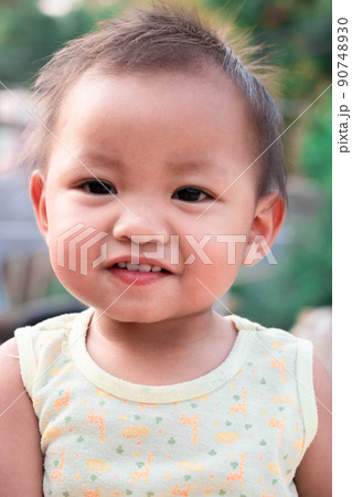 A 2-year-old girl is having fun and is happy and showing her baby teeth. A 2-year-old girl is having fun and is happy and showing her baby teeth. 90748930