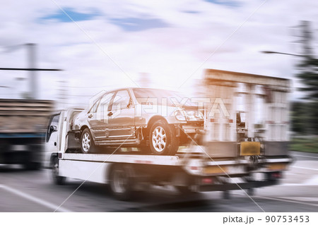 Broken car on tow truck after traffic accident, on the road service 90753453