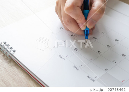 Woman hand with pen writing on calendar date business planning appointment meeting concept 90753462