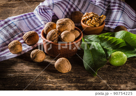 Walnut kernels on a dark table with a colored background 90754225