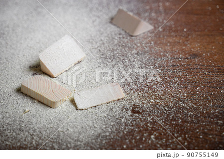 cut pieces of wood with sawdust on brown wooden floor cut pieces of wood with sawdust on brown wooden floor 90755149