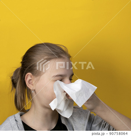 Sick girl sneezing and blowing nose Sick girl sneezing and blowing nose 90758064