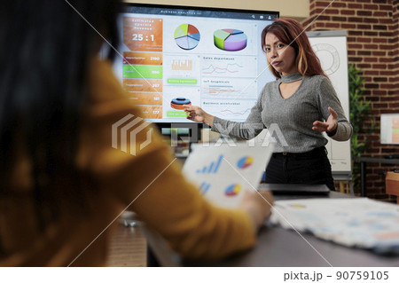 Asian manager discussing management statistics with entrepreneur woman during business meeting in startup office. Businesswomen working at company strategy planning marketing project Asian manager discussing management statistics with entrepreneur woman during business meeting in startup office. Businesswomen working at company strategy planning marketing project 90759105