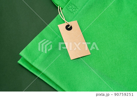 Textile shopping bag on green background flat lay 90759251