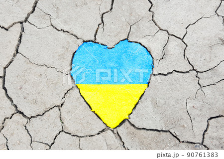 Heart with flag of Ukraine on cracked earth background 90761383
