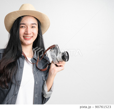 Asian woman holding vintage camera with copy space. Travel concept Asian woman holding vintage camera with copy space. Travel concept 90761523