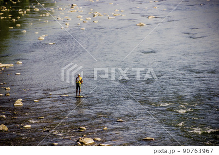 a fisherman on the stone in the middle of Opir river, Skole Beskids National Nature Park, Ukraine 90763967