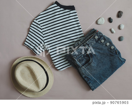 Summer fashion, vacation on sea. flat lay with t-shirt, denim shorts, straw hat top view Summer fashion, vacation on sea. flat lay with t-shirt, denim shorts, straw hat top view 90765903