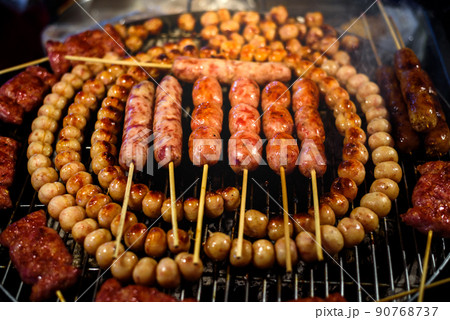 Thai style sausage grilling on stove at night market , Chiang mai , Thailand Thai style sausage grilling on stove at night market , Chiang mai , Thailand 90768737