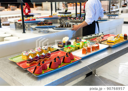 Photo of a sweet table for the holiday pastries and cakes in the hotel bar with staff Photo of a sweet table for the holiday pastries and cakes in the hotel bar with staff 90768957