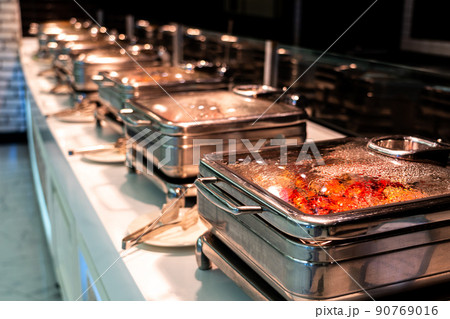 Catering buffet food with heated trays ready for service in hotel restaurant Catering buffet food with heated trays ready for service in hotel restaurant 90769016