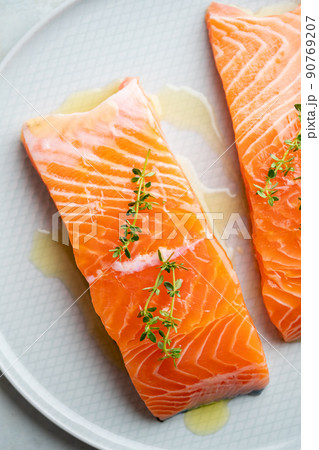 Fresh salmon fillet with herbs on a plate for delicious salmon steak. Fresh salmon fillet with herbs on a plate for delicious salmon steak. 90769207