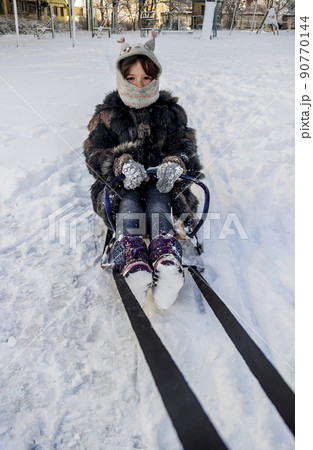 little girl on sledge 90770144