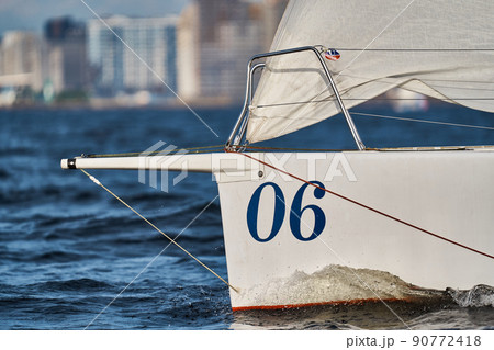 Bowsprits of sailing yachts in sailing regatta at sunset, still water, the clear sky, hot racing 90772418