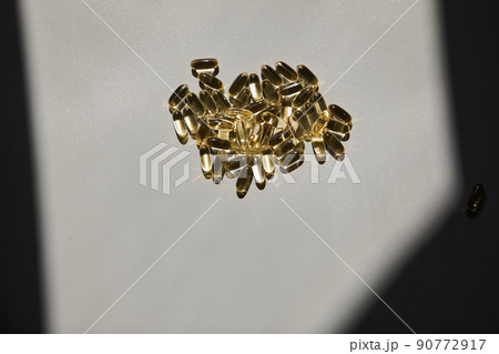 Omega 3. Transparent fish oil capsules on a gray background Omega 3. Transparent fish oil capsules on a gray background 90772917