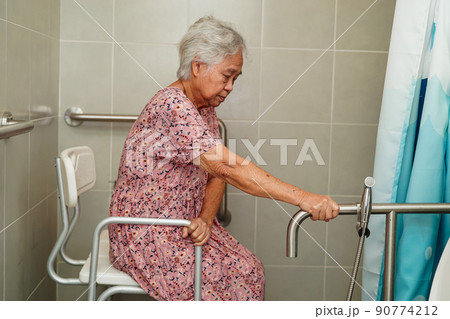 Asian senior or elderly old lady woman patient use toilet bathroom handle security in nursing hospital ward, healthy strong medical concept. Asian senior or elderly old lady woman patient use toilet bathroom handle security in nursing hospital ward, healthy strong medical concept. 90774212