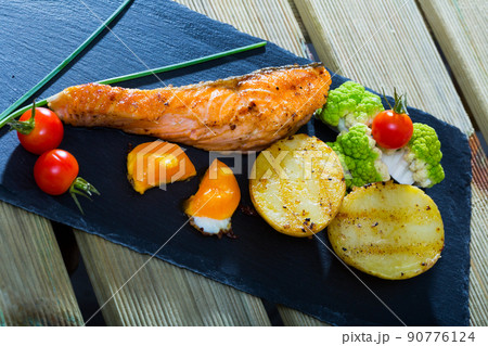 Grilled salmon with egg yolk and vegetables 90776124