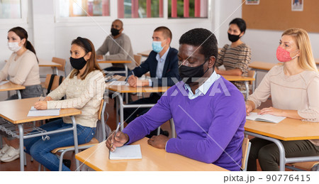 Adult African American in protective mask at refresher course 90776415
