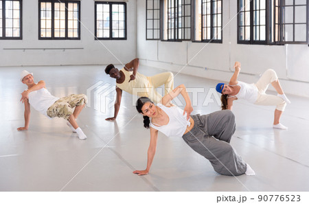 Group of young people learning modern dance movements Group of young people learning modern dance movements 90776523