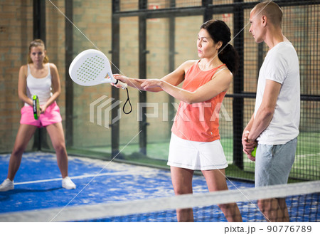 Portrait of concentrated trainer teaching young player Portrait of concentrated trainer teaching young player 90776789