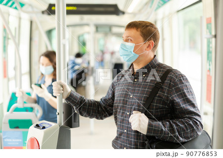 Portrait of male passenger in personal protective equipment traveling in transport Portrait of male passenger in personal protective equipment traveling in transport 90776853