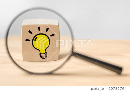 Magnifying glass with light bulb icon. Concept creative idea and innovation. Idea and imagination. Creative and inspiration. Magnifying glass with light bulb on a wooden background Magnifying glass with light bulb icon. Concept creative idea and innovation. Idea and imagination. Creative and inspiration. Magnifying glass with light bulb on a wooden background 90782764