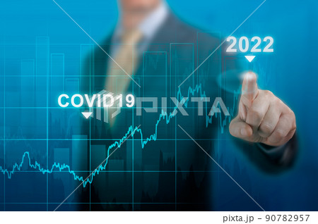 economic recovery in 2022. timeline chart diagram of global economic recovery after the crisis caused by the covid19 pandemic. Businessman pointing graph corporate future growth plan on dark blue economic recovery in 2022. timeline chart diagram of global economic recovery after the crisis caused by the covid19 pandemic. Businessman pointing graph corporate future growth plan on dark blue 90782957