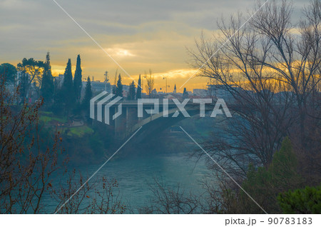 Blazo Jovanovic Bridge over the river Moraca in Podgorica, capital of Montenegro. evening, winter, sunset, dawn Blazo Jovanovic Bridge over the river Moraca in Podgorica, capital of Montenegro. evening, winter, sunset, dawn 90783183